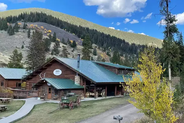Aerial view of winding river and Darwin ranch amongst the mountains of Wyoming