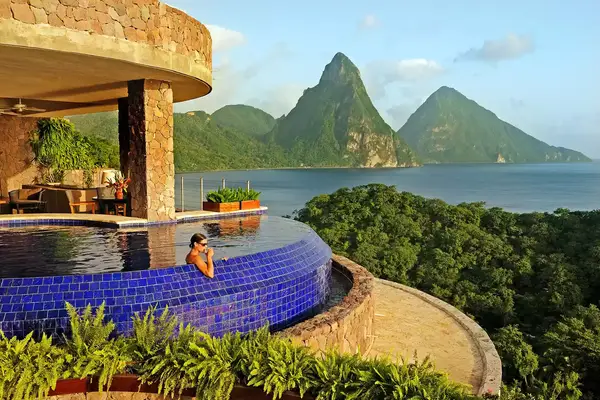 Woman drinking a drink in an infinity pool