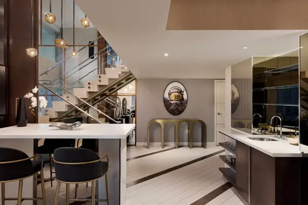 Modern kitchen and dining area with contemporary design featuring a staircase and decorative wall art