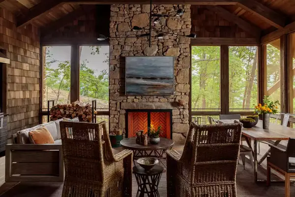 Seating area with a fireplace and a view of the tress at Blackberry Mountain