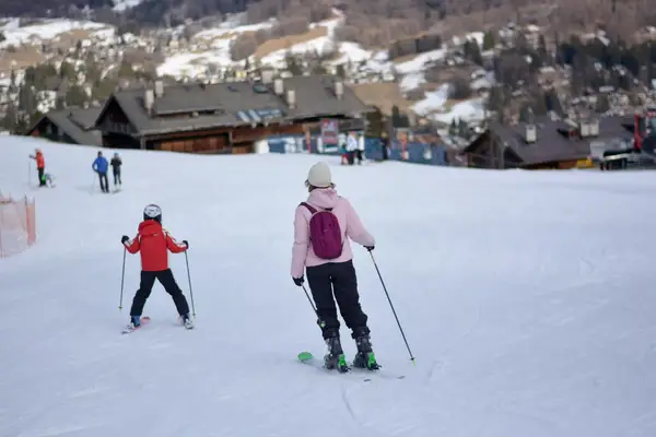 Children skiing down a hill