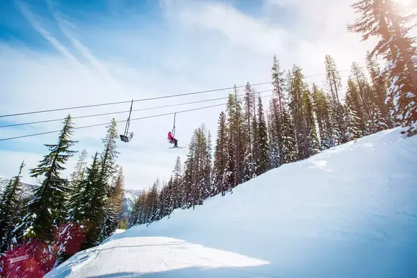 A ski lift taking skiers up a mountain