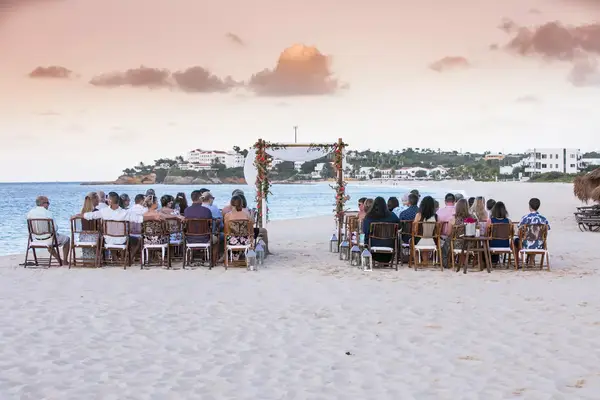 Guests seated at a wedding on the beach