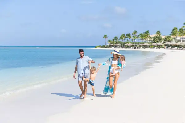 Family walking down the beach