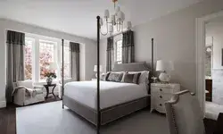 Elegant bedroom with a fourposter bed and chairs by a window