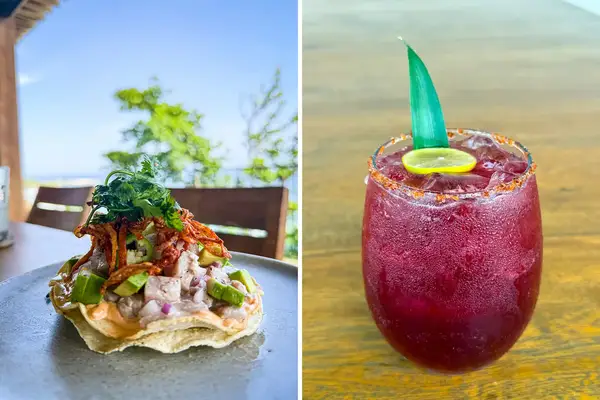 A plate of tostada next to a glass of red beverage garnished with lime and greenery