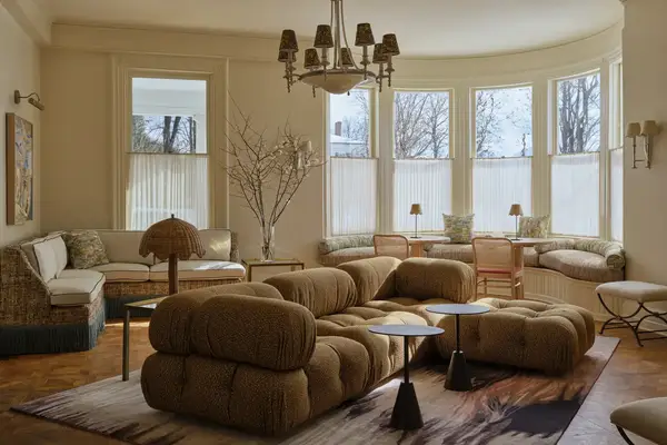 Spacious living room with modern furniture, large windows, and natural light