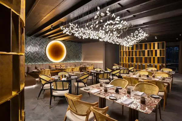 Upscale restaurant interior with modern decor, tables, and chairs