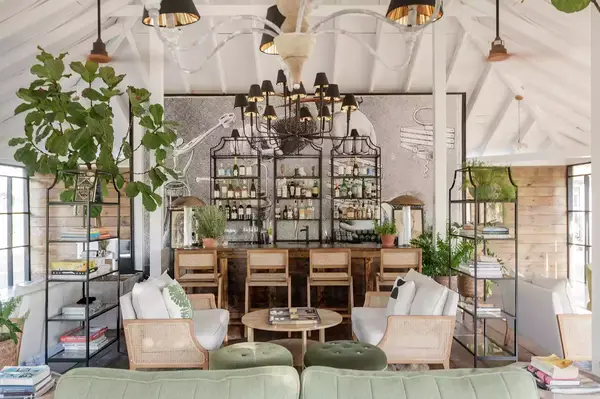 A stylish bar area with wooden stools and indoor plants