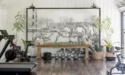A home fitness space featuring exercise equipment and a rustic aesthetic, with a large mural as the centerpiece