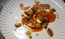 A gourmet seafood dish arranged artfully on a white plate