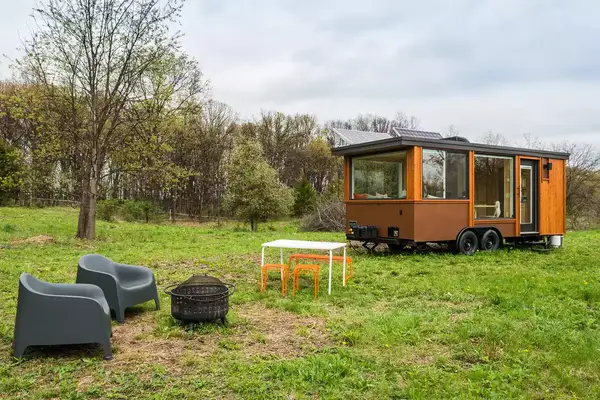Chairs around a firepit outside of The Glass House: A Hudson Valley Tiny Home Escape