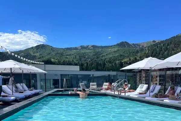 People lounge by pool at Pendry Hotel in Park City