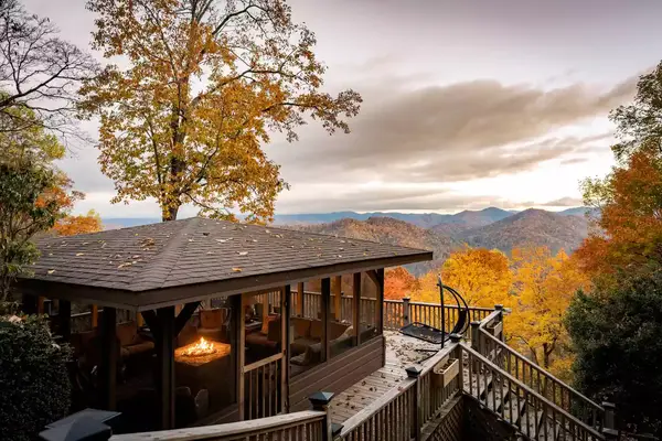 View of sky high lodge with fireplace and sweeping view autumn foliage on the mountain tops 