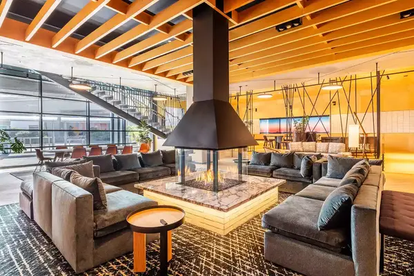 Interior of a lounge with fire pit at The Shay 