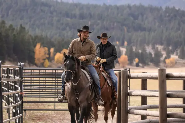 Luke (L-Luke Grimes) and John (R-Kevin Costner) take a break from their problems on the Dutton Ranch with a ride on Paramount Network
