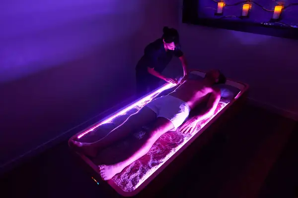 A man getting a quartz massage at a spa