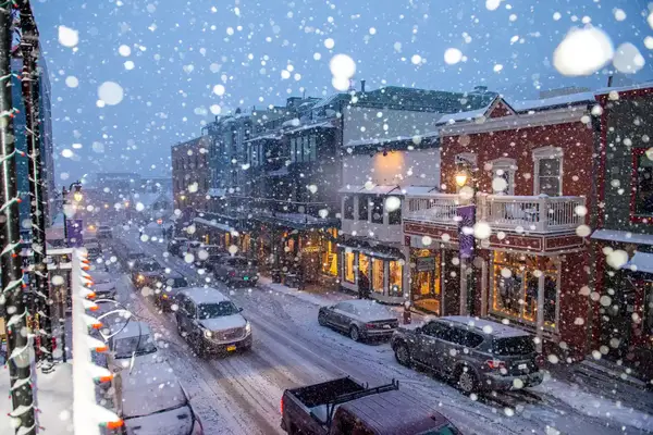 Snow falling over the town of Park City, Utah, in winter. 