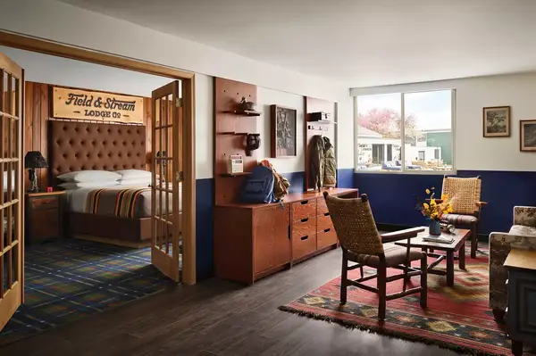 Comfortable hotel room with rustic decor and a view of a bright outdoors through the window