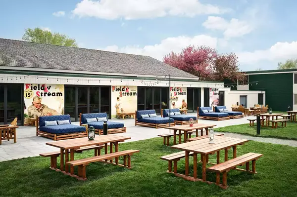 Outdoor seating area with wooden furniture, banners reading 