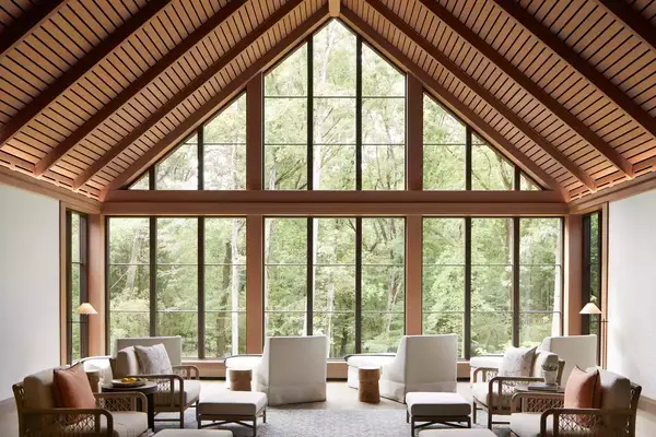 Spa lounge area with large windows overlooking forest