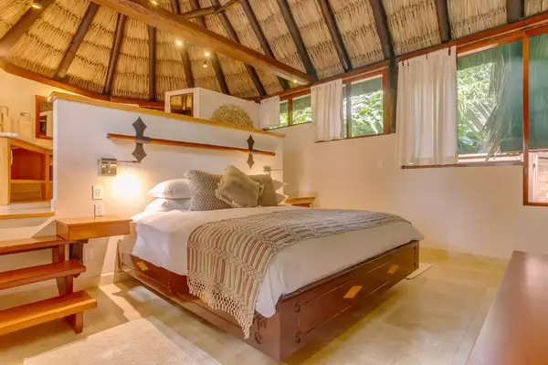 treetop hotel villa bed with bathroom behind bed