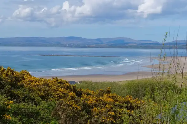 Coastal landscape with the sea waves and distant hills