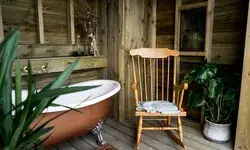 Wooden interior room with a bathtub plant and chair