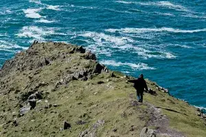 A woman on Dunmore Head in Dingle, Ireland 
