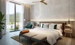 Modernly designed guest room with a bed, chair, and large window overlooking a scenic outdoors, part of a hotel setting