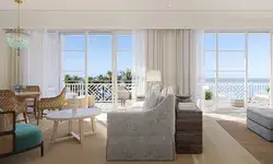 Elegant living room with sea view, large windows, and modern furnishings