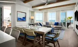 A spacious modern living room with dining area and ocean view