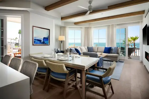 A spacious modern living room with dining area and ocean view
