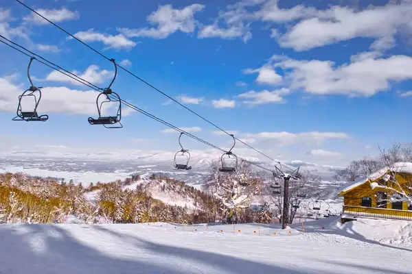 A mountain lodge-style restaurant and ski lift near the top station of the Furano ropeway