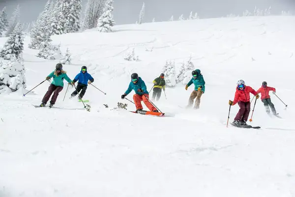 A group of skiers going downhill