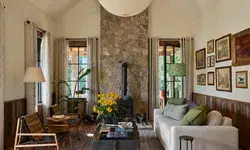 A cozy cabinstyle living area with a stone fireplace seating and decor emphasizing natural elements