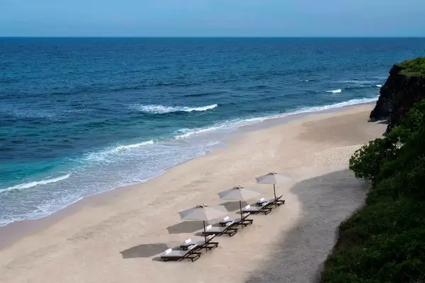 Lounge chairs on the beach at Jumeriah Bali