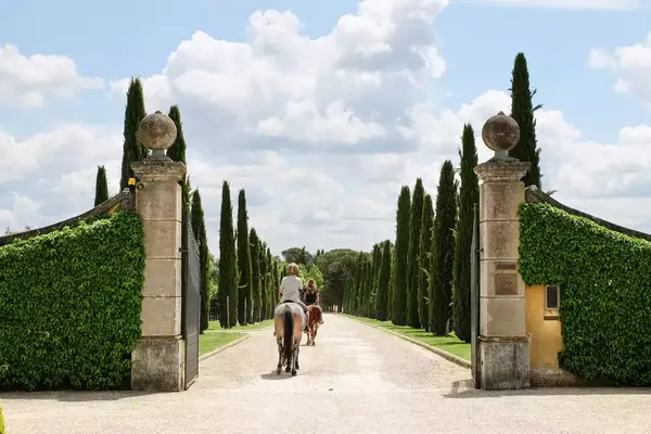 Riding horses through the grounds at Il Borro