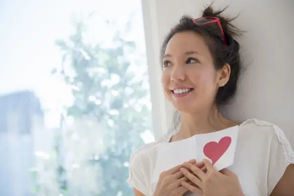 a woman holding a piece of paper