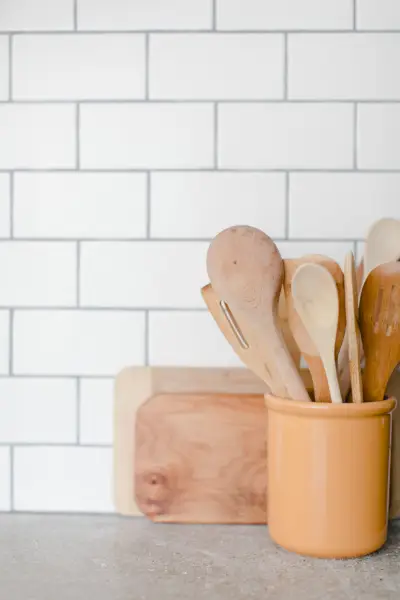 wooden kitchen utensils in yellow container