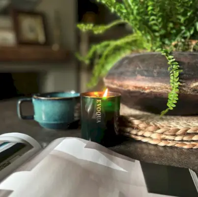 cozy winter home interior details, cup of coffee, wooden tray, tangerine and candle window sill still life for christmas