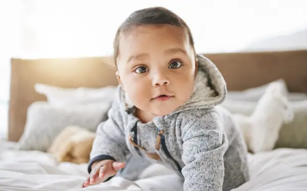 shot of an adorable baby boy playing on the bed at home