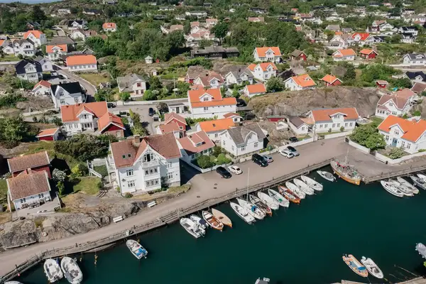 A coastal town in Southern Norway with houses a pier and docked boats