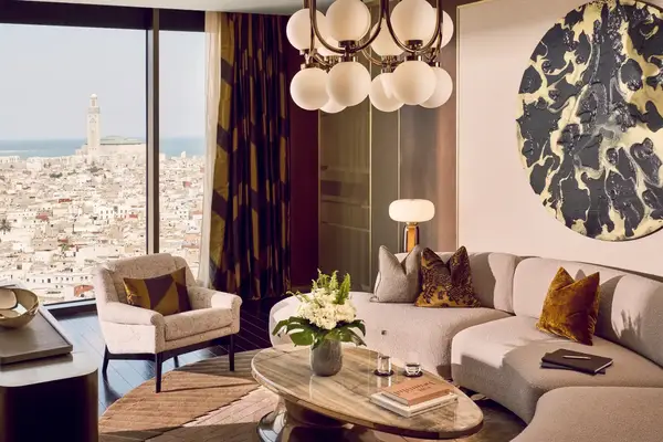 Luxurious suite interior with a view of a cityscape and a landmark minaret tower