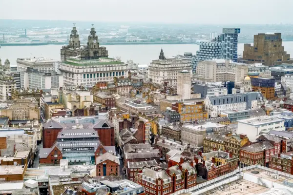 elevated view of liverpool iconic skyline from inland, looking out to sea early sunset time east wirral can be seen in the distance, including the birkenhead docks, seacombe, royal liver building , three graces and wallasey3 november 2015