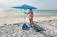Person setting up beachBUB All-In-One Beach Umbrella System on beach