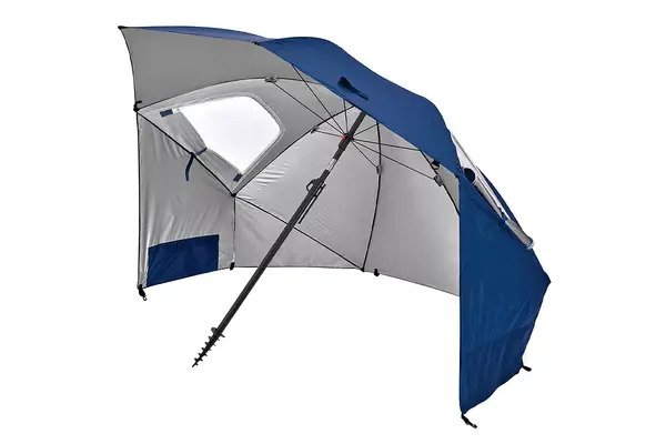 The OutdoorMaster Beach Umbrella with Sand Bag setup on the beach