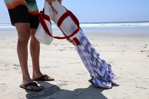 A person removes the CoolCabanas CoolCabana 5 from the storage bag