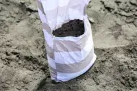 A leg pocket on the CoolCabanas CoolCabana 5 filled with sand