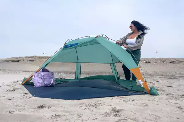 A person assembles the Kelty Cabana Shelter